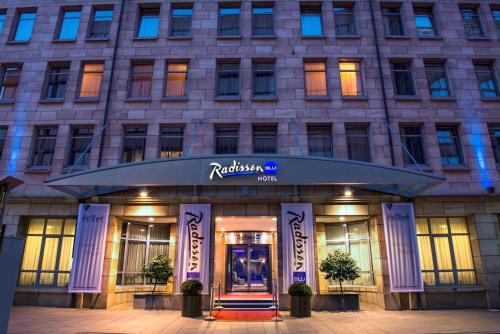 a hotel with a sign on the front of a building at Radisson Blu Hotel Bremen in Bremen