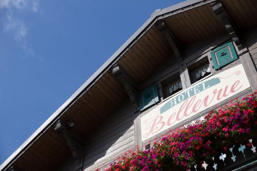 a sign on the side of a building with flowers at Bellevue in Les Gets