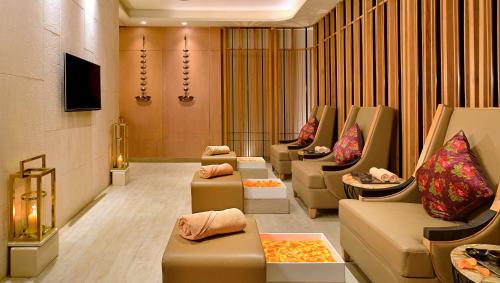 a waiting room with couches and chairs in a building at Radisson Mumbai Goregaon in Mumbai