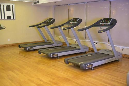 a row of three exercise bikes in a gym at Radisson Blu Hotel, Cairo Heliopolis in Cairo