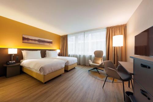 a hotel room with a bed and a flat screen tv at Radisson Blu Hotel, Lucerne in Luzern