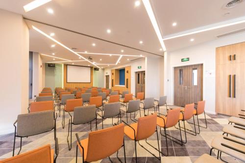 a conference room with chairs and a whiteboard at Holiday Inn Express Shanghai Tangzhen by IHG - 20 mins to PVG Airport and Disney land in Shanghai