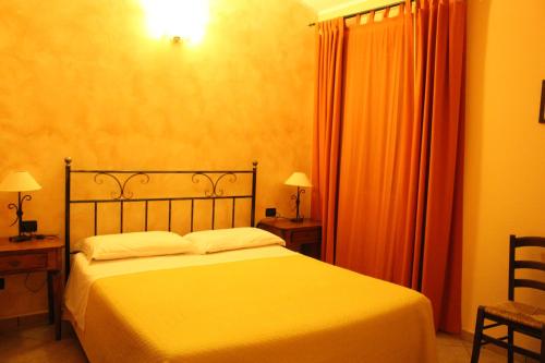 a bedroom with a bed and two tables and two lamps at Angelucci Agriturismo con Camere e Agri Camping in Lanciano