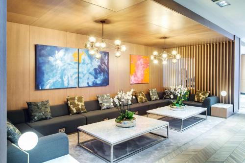 a living room with a couch and two tables at Radisson Blu Hotel, Glasgow in Glasgow