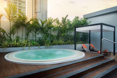 a jacuzzi tub in a building with plants at Radisson Suites Bangkok Sukhumvit in Bangkok