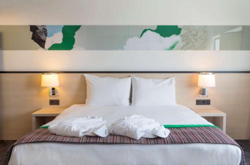 two towels on a bed in a hotel room at Park Inn by Radisson Leuven in Leuven