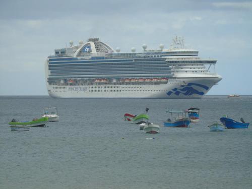 a cruise ship in the ocean with boats in the water at Hostal Villas Mexico in San Juan del Sur