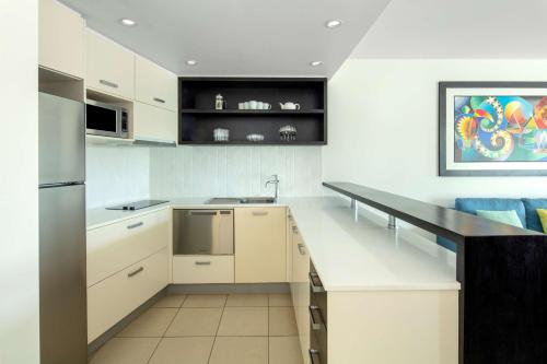 a kitchen with white cabinets and a counter top at Radisson Blu Resort Fiji in Denarau