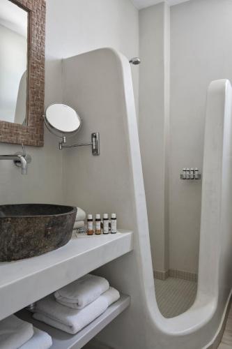 a white bathroom with a sink and a shower at DUNES - Semi Based Apartment with Indoor Garden - Part Of White Dunes Luxury Boutique Hotel in Santa Maria