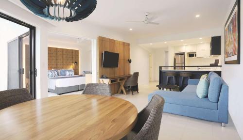 a living room with a blue couch and a table at Radisson Blu Resort Fiji in Denarau