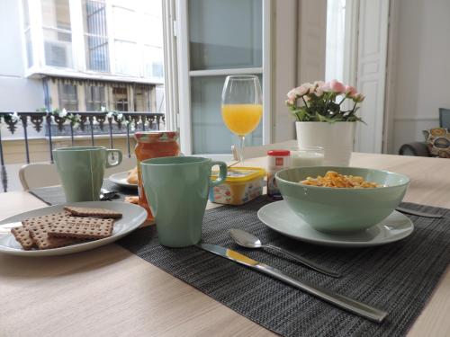 a table with a plate of food and a glass of orange juice at Casita de Santos in Málaga