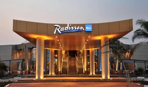 a building with a sign on top of it at Radisson Blu Hotel Lusaka in Lusaka