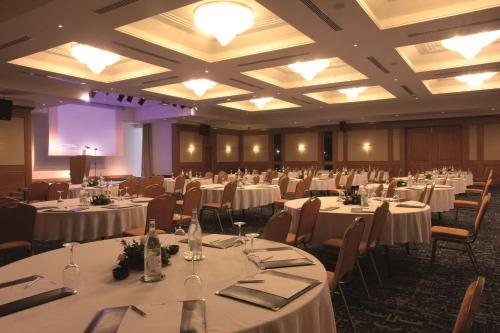 a banquet hall with white tables and chairs at Radisson Blu Resort & Thalasso Hammamet in Hammamet