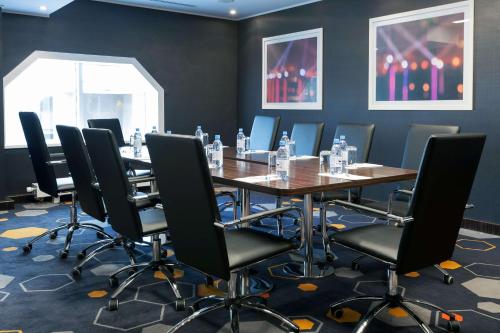a conference room with a long table and chairs at Park Inn by Radisson Hotel Astana in Astana