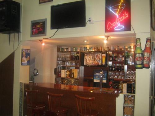 a bar with a television on the wall at Hotel Cisne II in Santa Elena