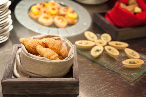 a table with a box of pastries and a plate of donuts at Park Inn by Radisson Hotel Astana in Astana