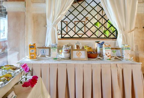 a table with food on it with a window at Colonna Park Hotel in Porto Cervo