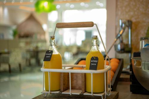 two bottles of orange juice sitting on a stand at Radisson Blu Resort Jizan in Jazan