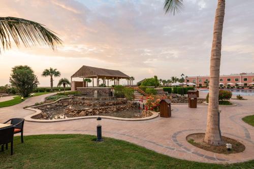 a park with a gazebo and a palm tree at Radisson Blu Resort Jizan in Jazan