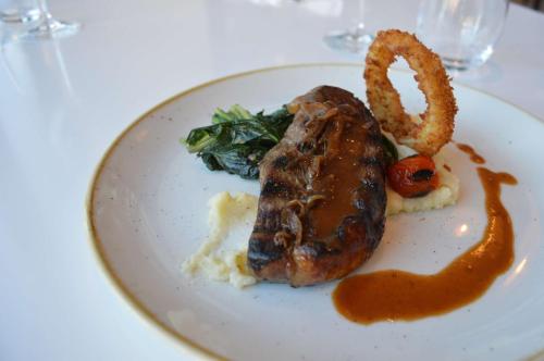 a plate of food with meat and vegetables on a table at Radisson Blu Hotel & Residence Maputo in Maputo