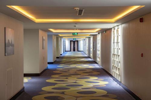 a hallway with a carpet on the floor in a building at Radisson Blu Resort Jizan in Jazan