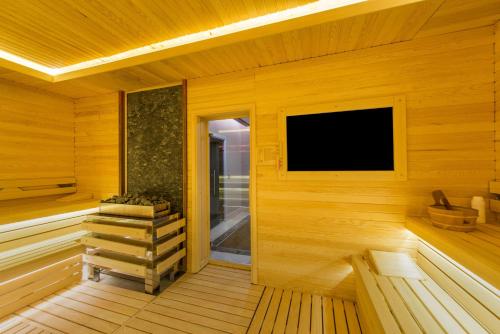 a sauna with a tv on a wooden wall at Radisson Blu Hotel, Ordu in Ordu