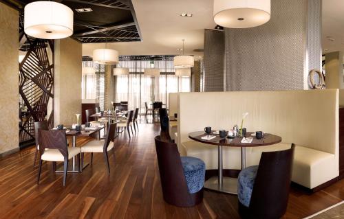 a dining room with tables and chairs and lights at Radisson Blu Hotel & Convention Centre Kigali in Kigali
