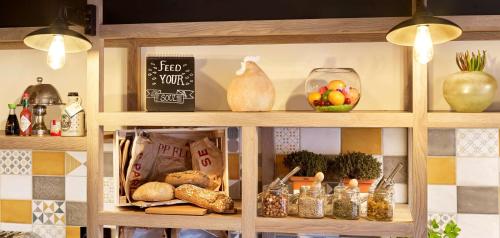 a shelf with food and other items on it at Park Inn By Radisson Hasselt in Hasselt