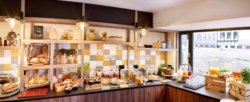 a bakery counter with a lot of food on it at Park Inn By Radisson Hasselt in Hasselt