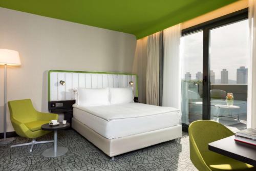 a hotel room with a bed and a table and chairs at Park Inn by Radisson Istanbul Atasehir in Istanbul