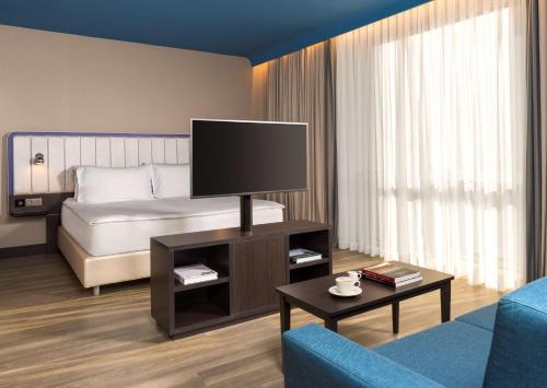 a hotel room with a bed and a television at Park Inn by Radisson Istanbul Atasehir in Istanbul