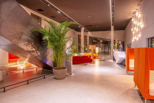 a lobby with a large potted plant in a building at Radisson Blu Hotel Bordeaux in Bordeaux