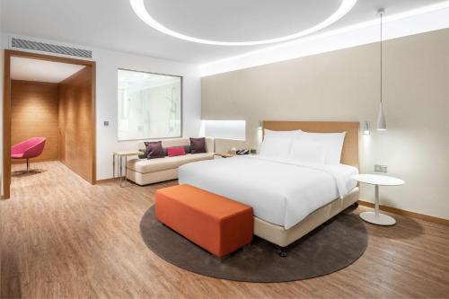 a hotel room with a bed and a couch at Radisson Blu Hotel & Residence, Riyadh Diplomatic Quarter in Riyadh