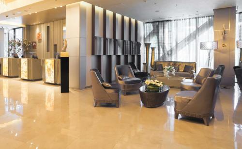 a lobby with chairs and couches in a building at The Legacy Luxury Hotel, Algiers in Alger