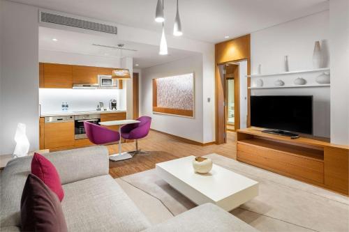 a living room with a couch and a table at Radisson Blu Hotel & Residence, Riyadh Diplomatic Quarter in Riyadh