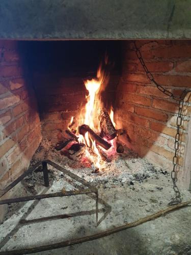 a brick oven with a fire in it at Agriturismo La Caraffara sull' Etna in Puntalazzo