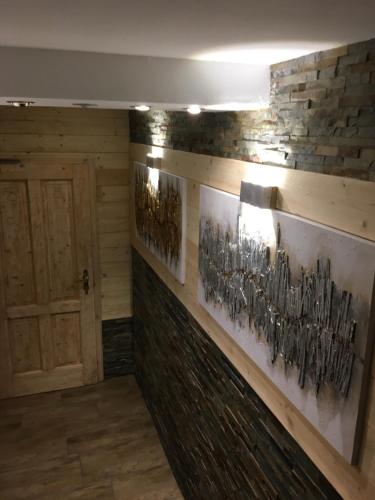a room with a wall with art on it at Haus Eder Steiner in Saalbach Hinterglemm