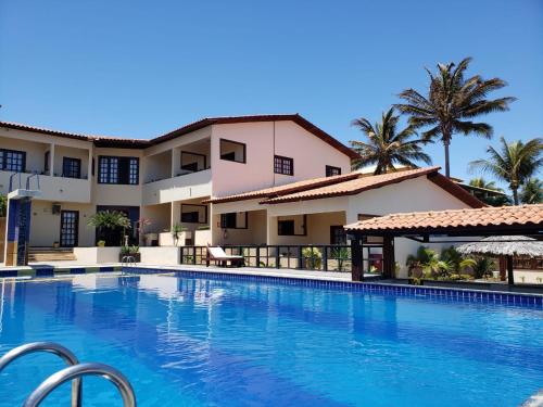 a large swimming pool in front of a building at Hotel Pousada Canoa Quebrada in Canoa Quebrada