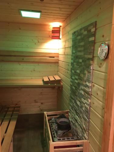 an empty sauna with a clock on the wall at Haus Eder Steiner in Saalbach Hinterglemm