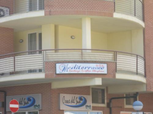 a building with a sign on the side of it at Residence Mediterraneo in Marina di Grosseto
