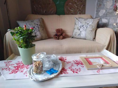 a living room with a coffee table with a couch at 1957 To Rodo kai to Roido in Karpenision