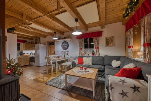 a living room with a couch and a table at CHALUPA NA VYHLÍDCE in Jeseník