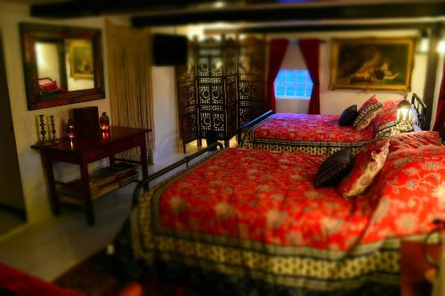 a bedroom with two beds and a table with a desk at Daniels House Inn in Salem