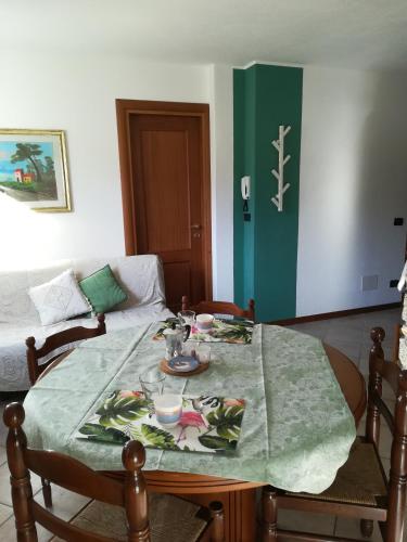 a table with a green table cloth on top of it at Il Nido B&B in Villa Dalegno