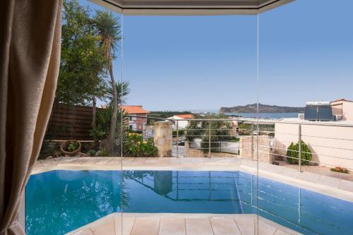 a view of a swimming pool from a house at Pantanassa Villas in Agia Marina Nea Kydonias