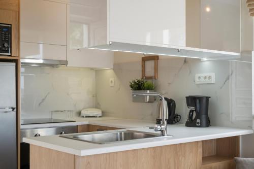 a kitchen with a sink and a counter top at Pantanassa Villas in Agia Marina Nea Kydonias