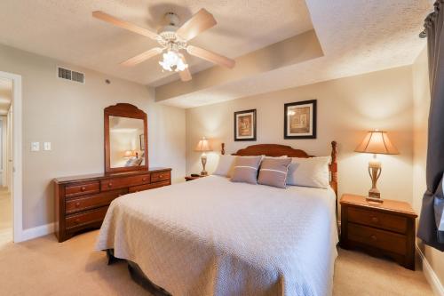 a bedroom with a bed and a ceiling fan at Riverside Escape & Roaring Romance in Gatlinburg