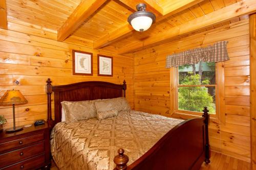 a bedroom with a bed in a log cabin at A Timeless Event in Pigeon Forge