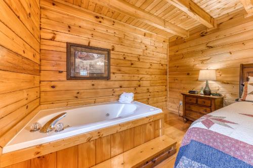 a bathroom with a tub in a log cabin at Affair of the Heart in Pigeon Forge