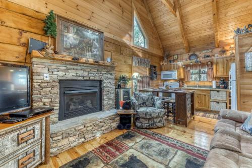 a living room with a fireplace and a tv at Pine Cone Ridge in Sevierville